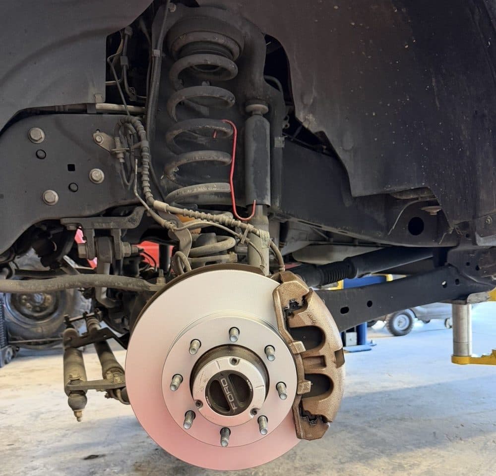 Brake rotor and hub exposed during a front suspension service at NorCal Precision Auto in Redding, CA