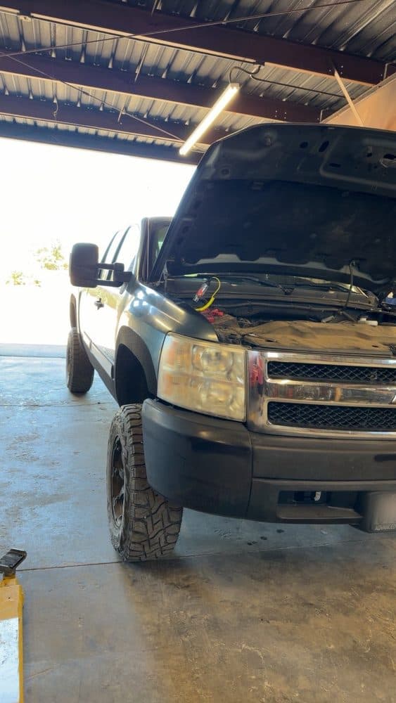 Chevrolet Silverado 2500HD with the hood open in the service bay at NorCal Precision Auto in Redding, CA