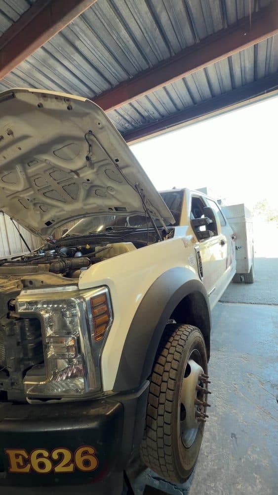 Ford fleet utility truck with the hood open for repair at NorCal Precision Auto in Redding, CA