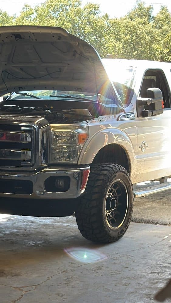 Ford F-250 Super Duty under service in a sunlit bay at NorCal Precision Auto in Redding, CA