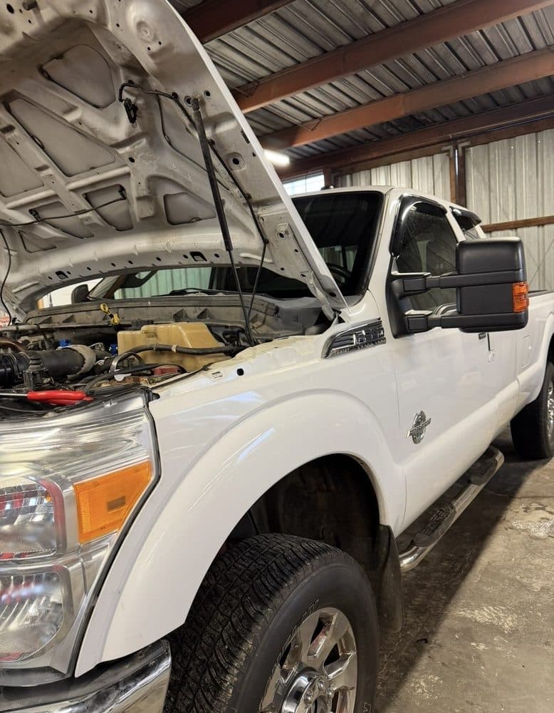 Ford F-250 Power Stroke diesel with the hood open in the bay at NorCal Precision Auto in Redding, CA