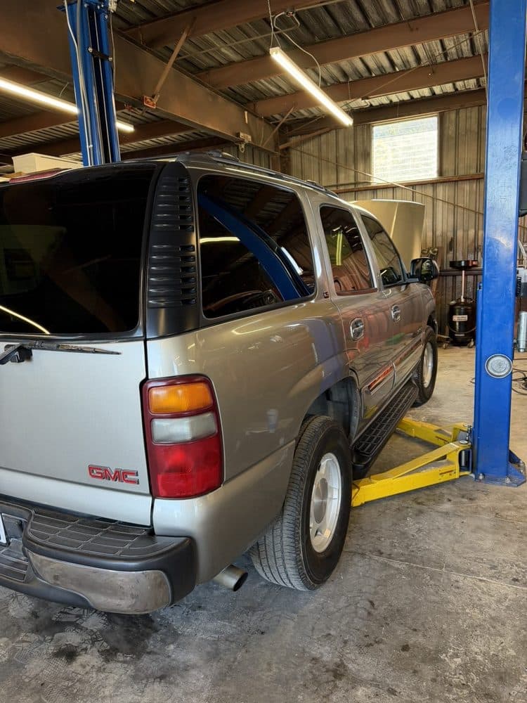 GMC Yukon raised on the lift for service at NorCal Precision Auto in Redding, CA