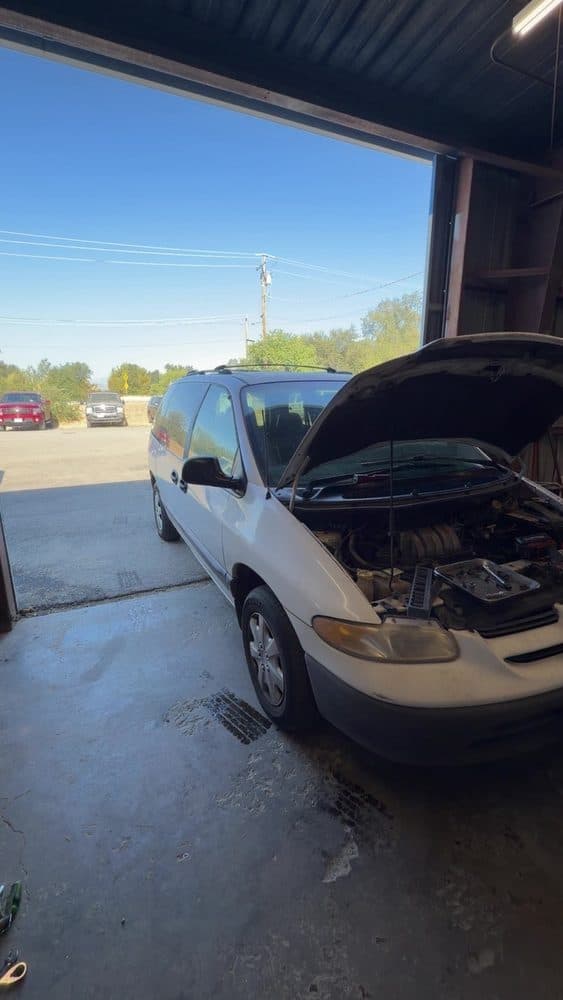 Minivan with the hood open for engine diagnostics at NorCal Precision Auto in Redding, CA