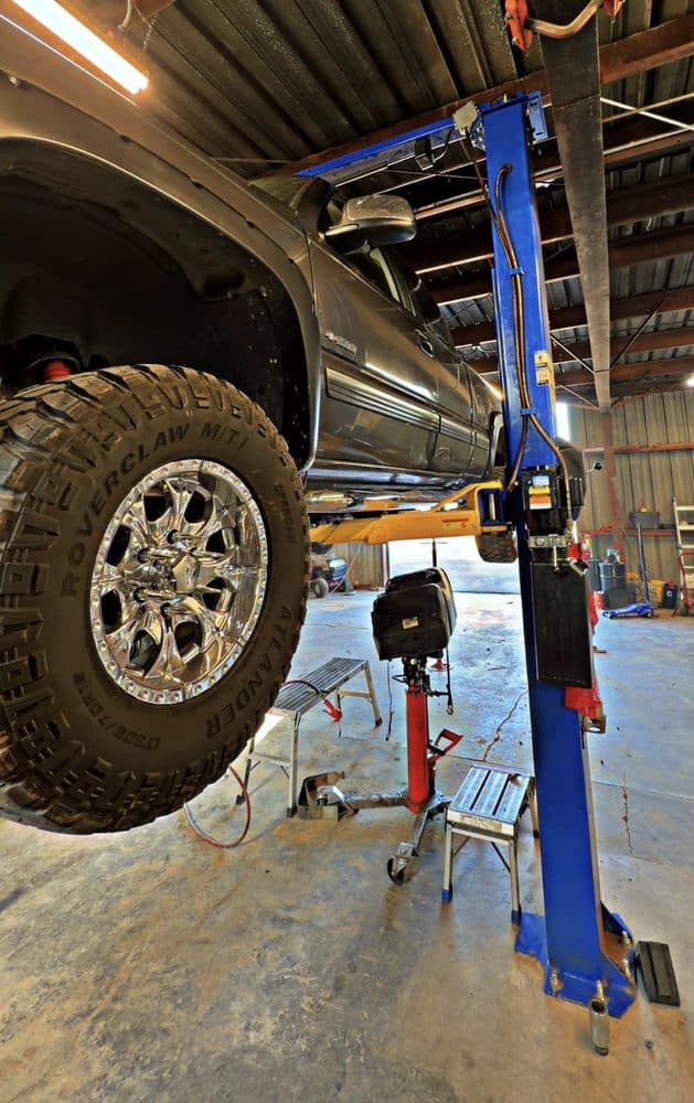 Underside of a lifted truck during a suspension inspection at NorCal Precision Auto in Redding, CA